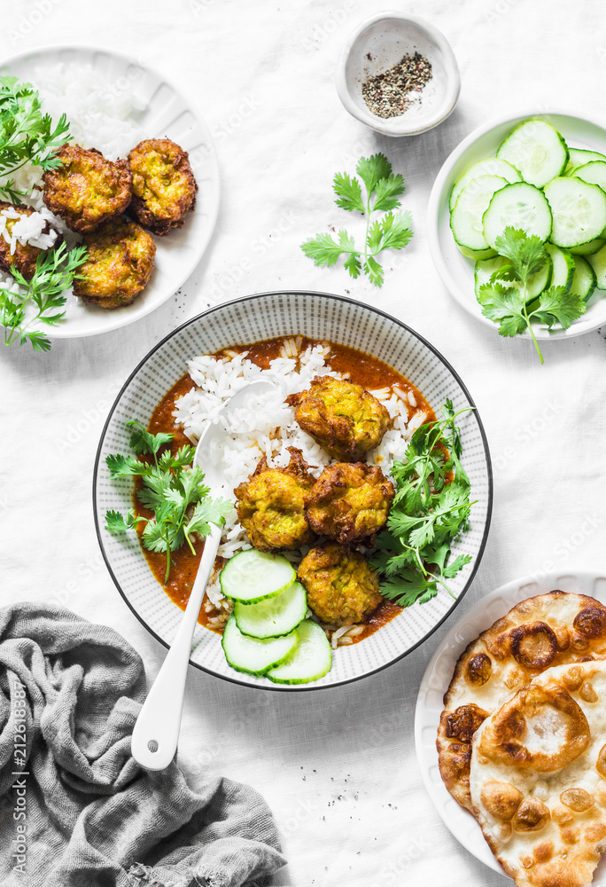 Vegetarian vegetable kofta with rice and curry sauce. Bottle gourd and zucchini fritters. Healthy vegetarian food on light background, top view