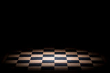 abstract chessboard on dark background lighted with snoot