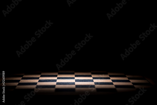 Valokuvatapetti abstract chessboard on dark background lighted with snoot