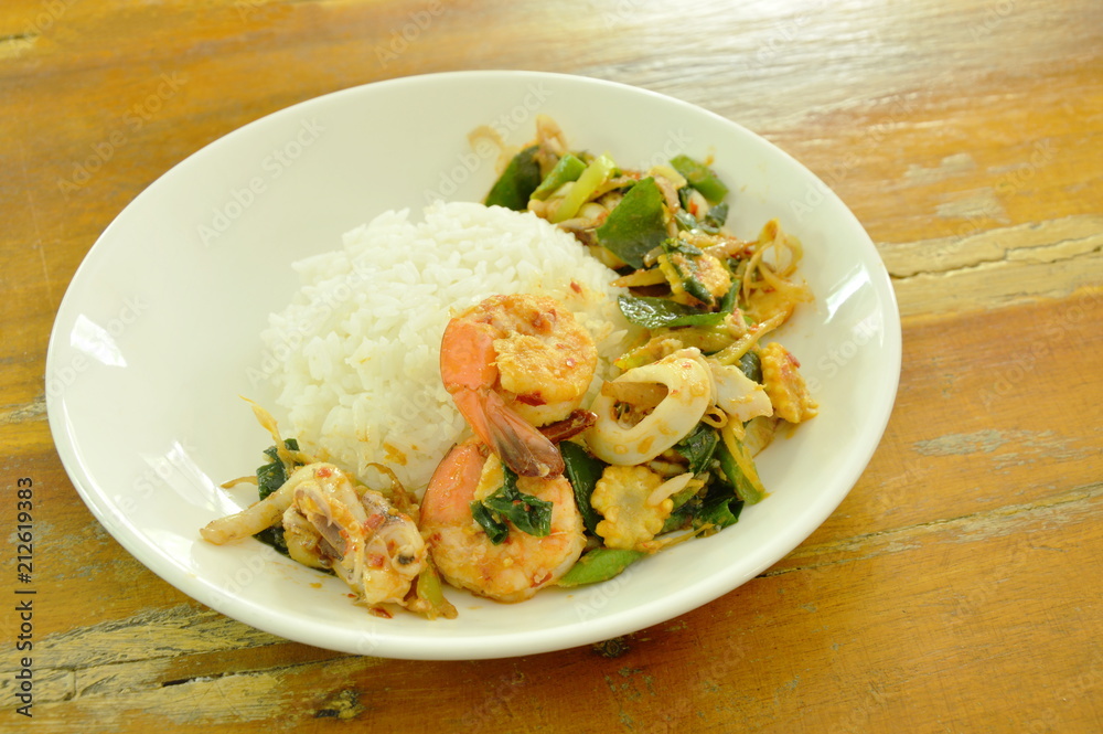 spicy fried shrimp and squid with herb on rice