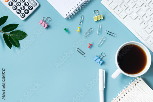 Top view keyboard,notebook,pen,paperclip or object for office supply concept on blue background.
