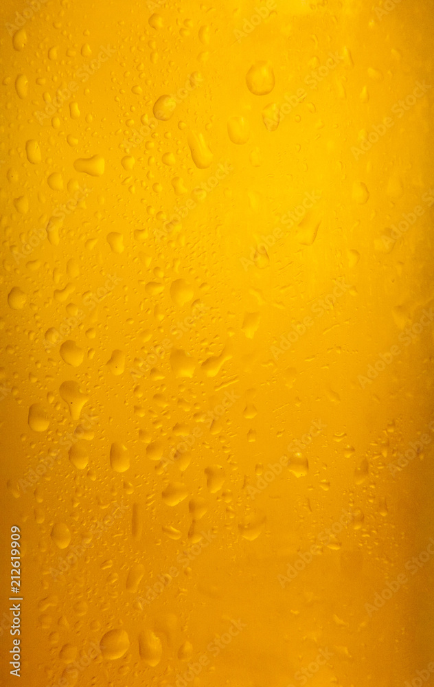 Vertical shot of a beer glass with cold drops falling down. Colorful vibrant orange surface.
Vertical shot of a beer glass with cold drops falling down. Colorful vibrant orange surface.