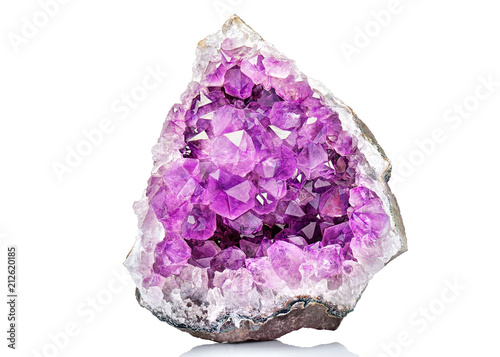 Violet Crystal Stone macro mineral. Purple rough Amethyst quartz crystals geode on white background, Uruguay