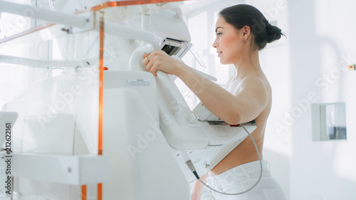 In the Hospital, Portrait Shot of Topless Female Patient Undergoing Mammogram Screening Procedure. Healthy Young Female Does Cancer Preventive Mammography Scan. Modern Hospital. photo