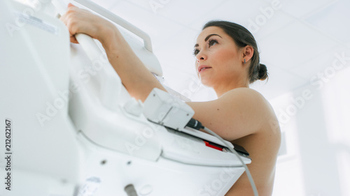 In the Hospital, Low Angle Portrait Shot of Topless Female Patient Undergoing Mammogram Screening Procedure. Healthy Young Female Does Cancer Preventive Mammography Scan. Modern Hospital