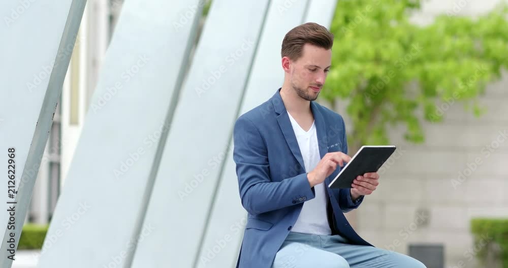 Businessman work on tablet computer in the city