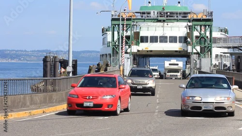 Pan of vehicles leaving the ferry.