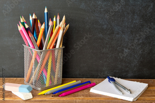 School supplies on blackboard background . The concept of education, study, learning, elearning. Back to schoolSchool supplies on blackboard background . The concept of education, study, learning photo