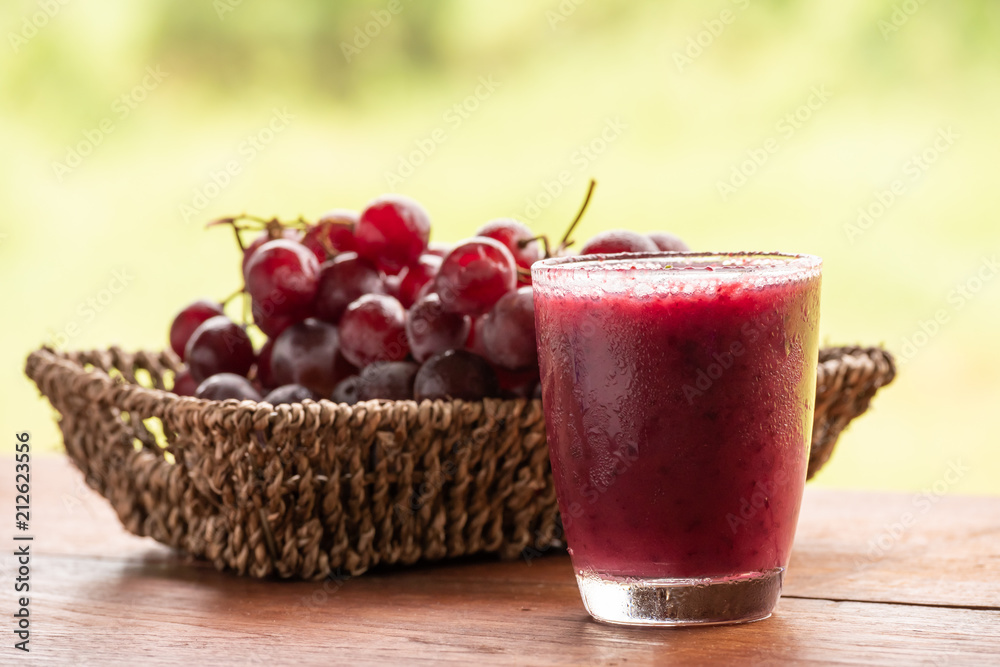 Glass of Grape juice smoothie on wooden table Glass of Grape juice smoothie on wooden table