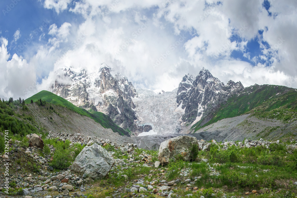 Amazing mountain Caucasus landscape of peaks of mountains Tetnuldi, Gistola and Dzhangi-Tau and glacier Lardaad in Svaneti, Georgia. View on Snowy Rocky mountains and Adishi glacier.