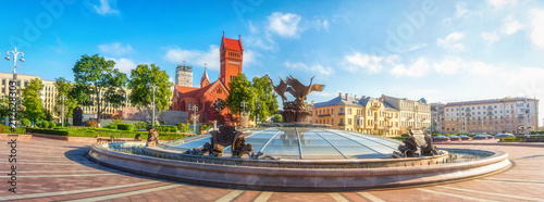 Panoramic view on Red Church or Church Of Saints Simon and Helen, Fountain at independence Square in Minsk, Belarus.
