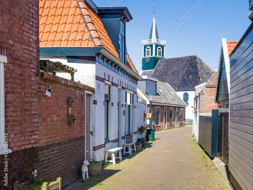 Принти на полотні Village Oudeschild with a row of  trraditional fisherman houses and an old churc