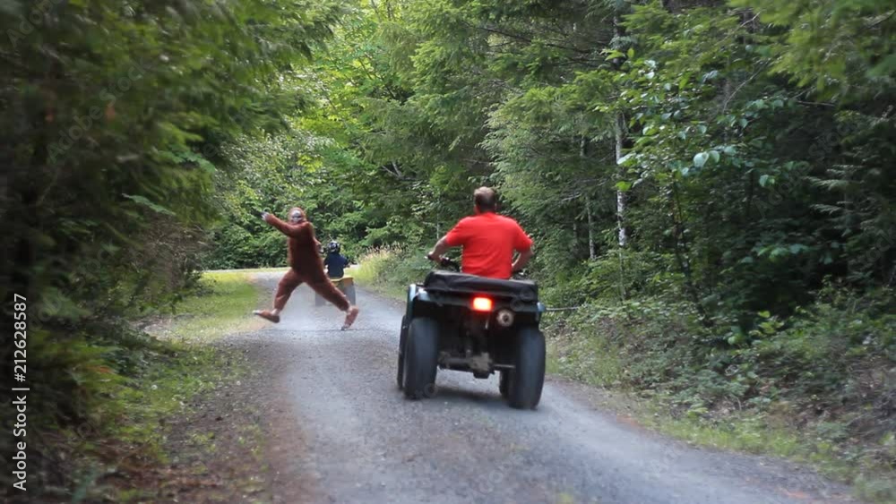 BIG FOOT or Sasquatch running in front of atv riders
