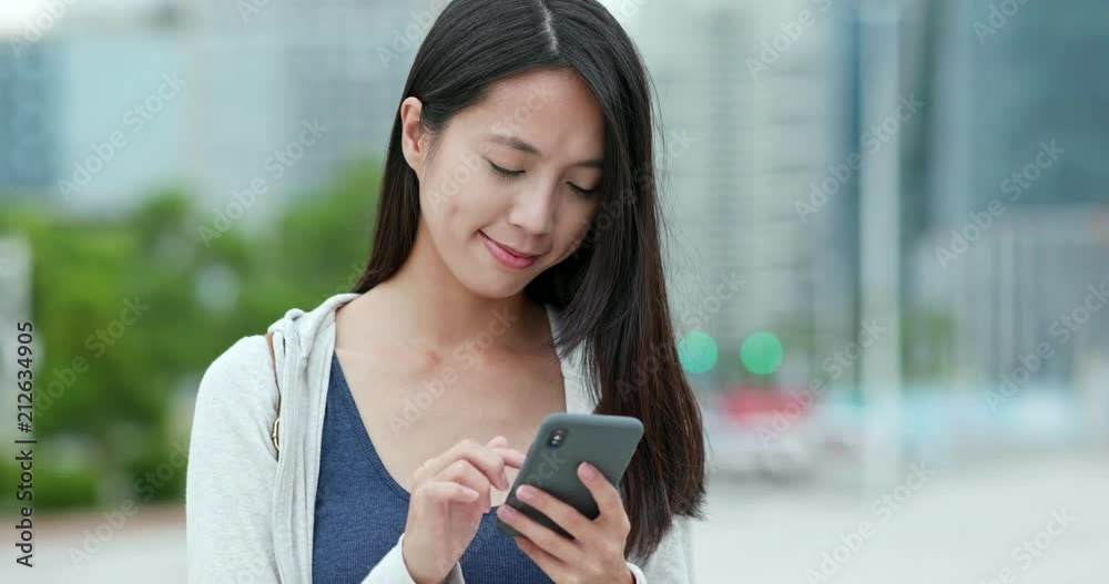 Woman working on mobile phone in Shenzhen city