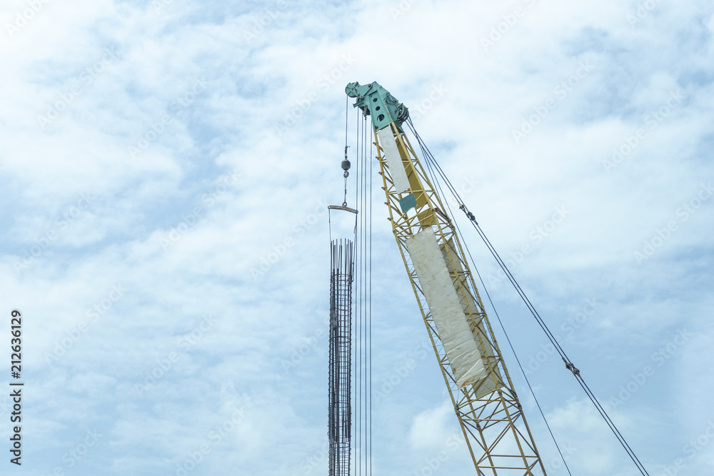 Crane lift green and yellow In the blue sky Crane lift green and yellow In the blue sky