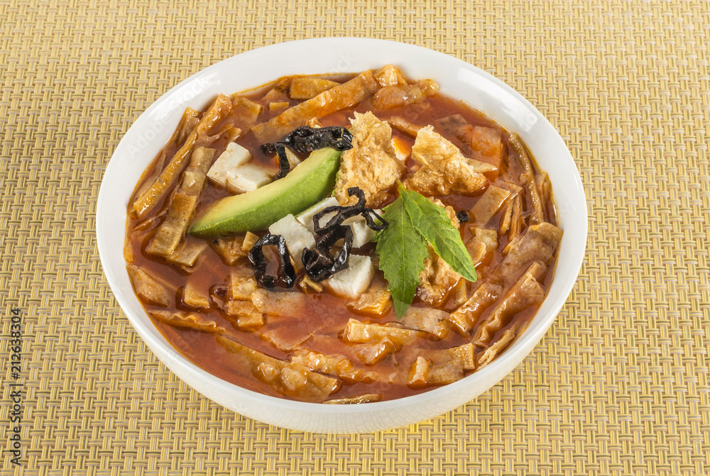 Mexican tortilla soup. Delicious tomato soup with tortilla chips Mexican tortilla soup. Delicious tomato soup with tortilla chips