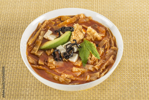 Mexican tortilla soup. Delicious tomato soup with tortilla chips