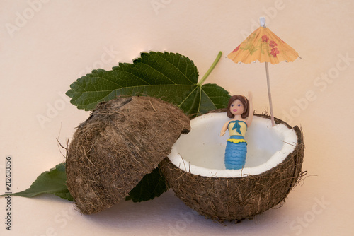 Simulación de una sirena bañándose en el agua de un coco. photo