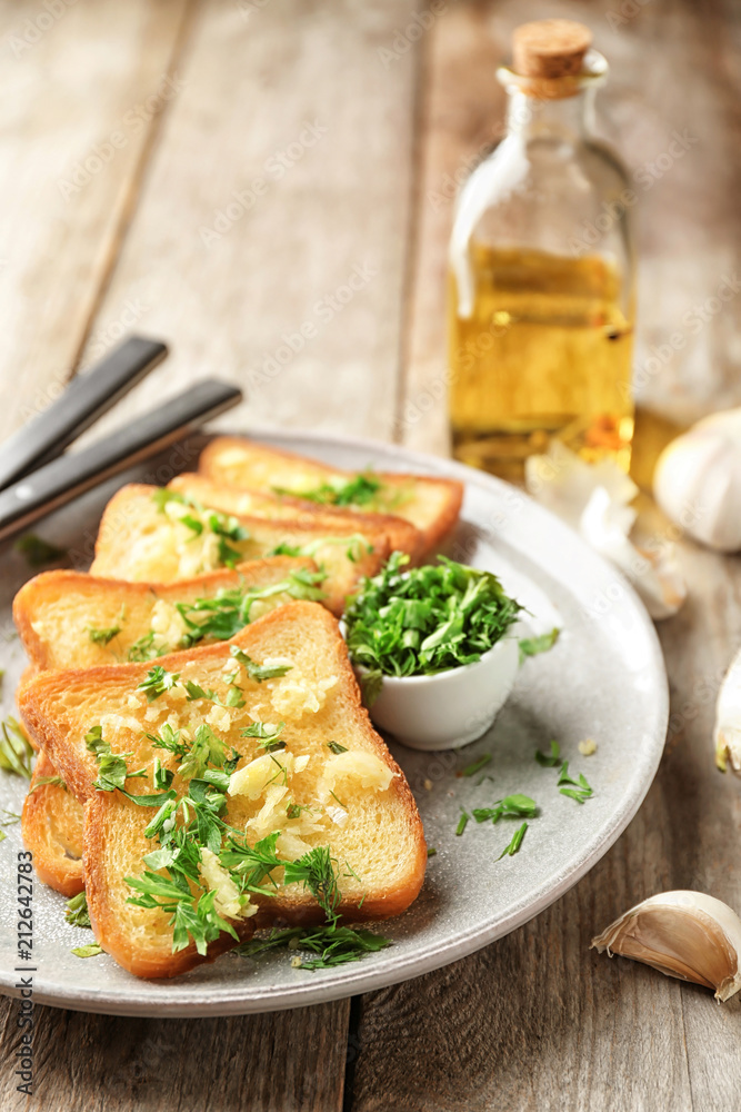 Plate with delicious homemade garlic bread on table Plate with delicious homemade garlic bread on table