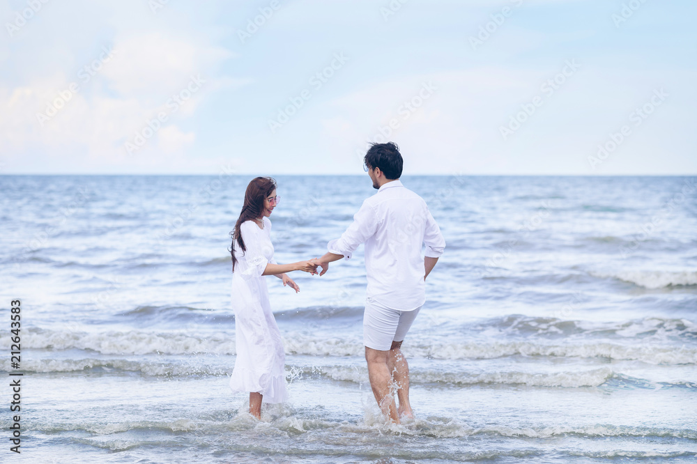 Beautiful couple in love dating outdoors and smiling on the breach