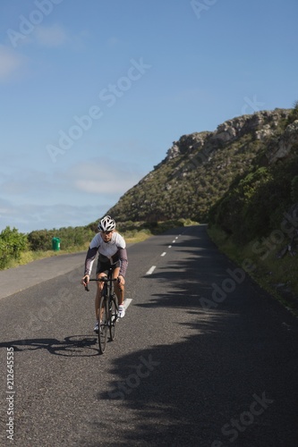 Biker riding mountain bike on road