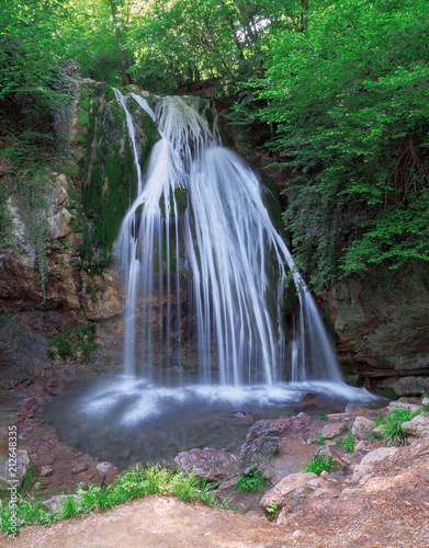 Big waterfall at the green forest in europe