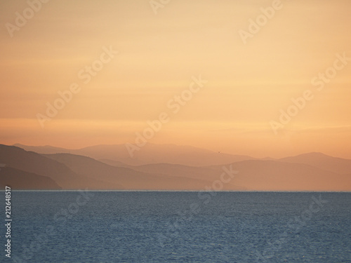 the sea and mountains during sunrise