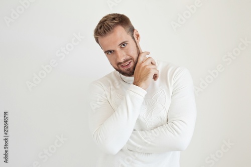 Handsome guy standing and smiling, over white background