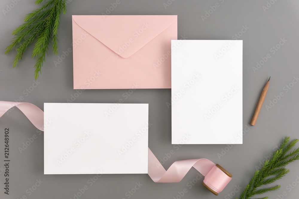 A wedding mock up concept. Wedding Invitation, envelopes, cards Papers on color background with ribbon and decoration. Top view, flat lay, copy space A wedding mock up concept. Wedding Invitation, envelopes, cards Papers on color background with ribbon and decoration. Top view, flat lay, copy space