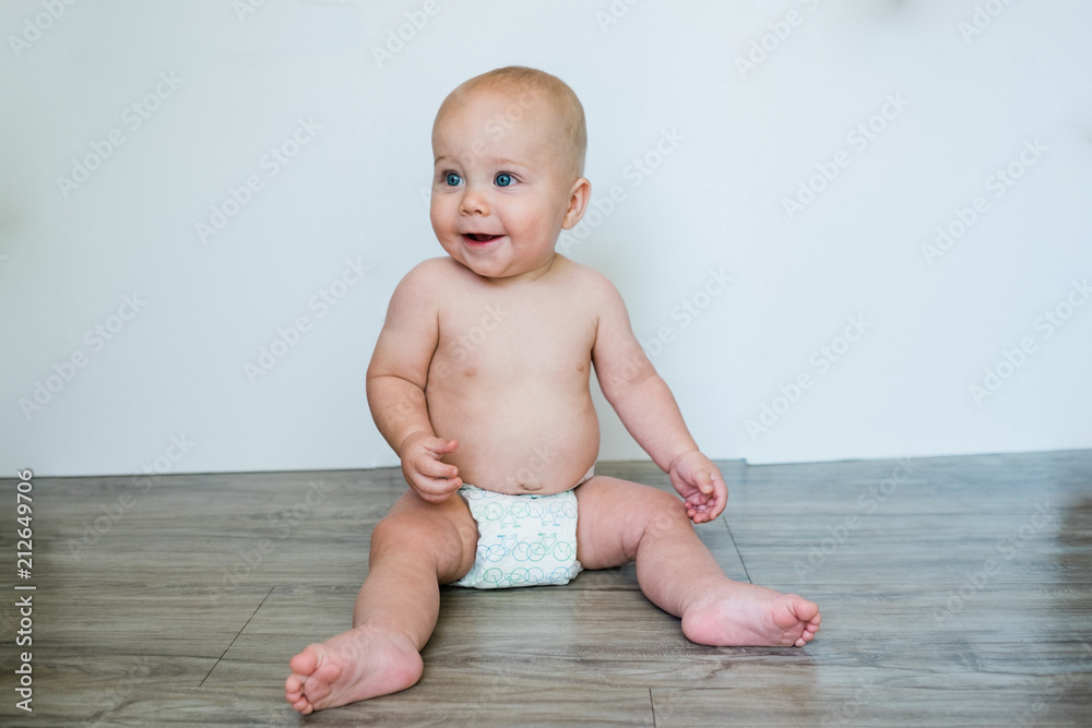 Smiling Baby Sitting on the Floor Smiling Baby Sitting on the Floor