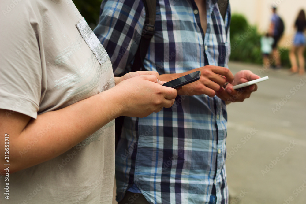 man and woman using smartphone