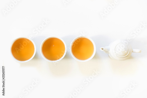 Green tea and cup of green tea on white. Top view and concept. Teatime. Copy space.