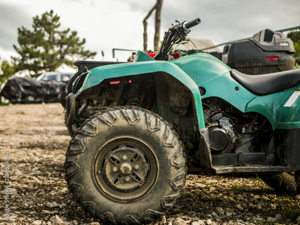 atv in a mountain parking zone on a rainy summer day atv in a mountain parking zone on a rainy summer day