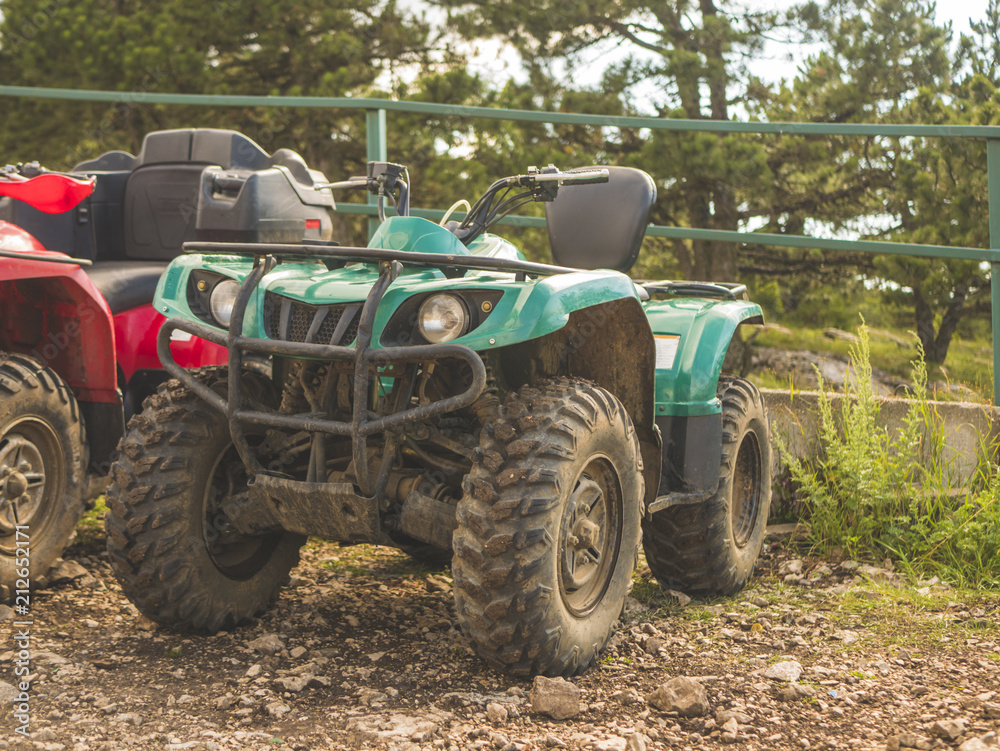 close up atv quad bike on a diry ground summer season close up atv quad bike on a diry ground summer season
