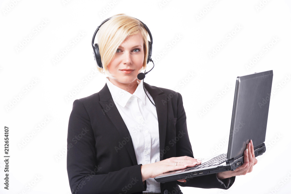 Call center operator, blonde woman dressed in black jacket holding laptop before white background with copyspace Call center operator, blonde woman dressed in black jacket holding laptop before white background with copyspace