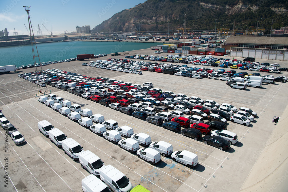  rows of cars on parking in sea port. Car export and import business. Car shipment. Shipping activity. Trade and car commerce