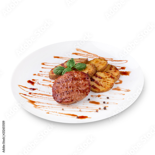 Grilled steak, baked potatoes, green basil and sauce on white plate