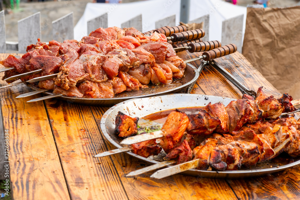 cooked meat on an open fire stacked on a metal dish cooked meat on an open fire stacked on a metal dish
