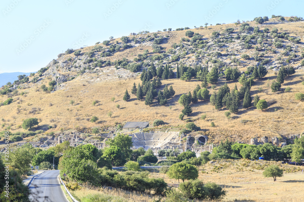 Small amphitheater and ruins from distance with the road in ephesus in Selcuk, Izmir, Turkey