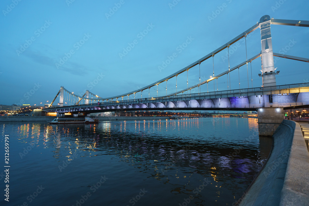 Fototapeta premium Brightly illuminated bridge at the sunset in Moscow