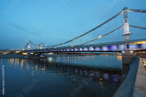 Fototapeta Naklejka Na Ścianę i Meble -  Brightly illuminated bridge at the sunset in Moscow