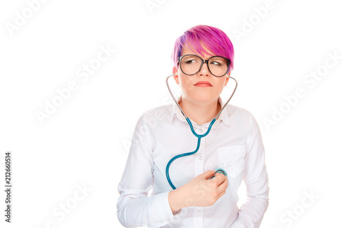 Confused woman listening herself with stethoscope