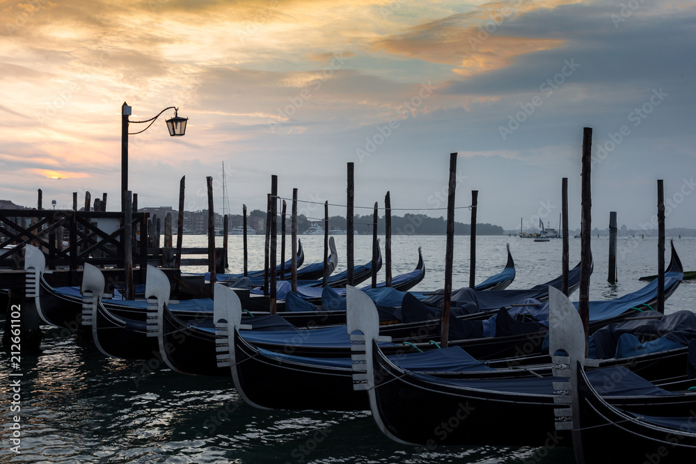 Moored goldolas in the early morning , Venice , Italy