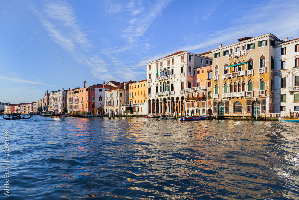 Boats, gondolas and colorful architecture viewed from boat in the Grand canal Italy