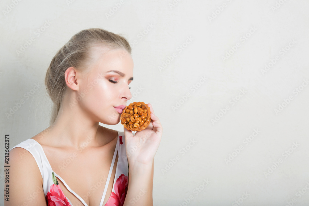 Stylish blonde lady enjoying sweet dessert with berries. Space for text