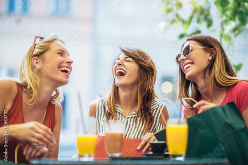 Three young women in a cafe after a shopping