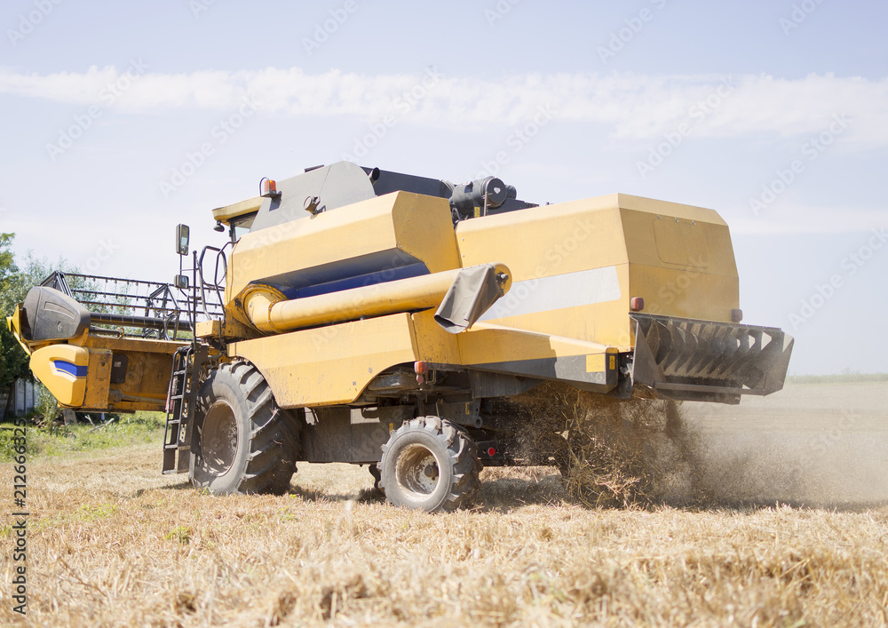 Combine harvester working on a wheat crop Combine harvester working on a wheat crop