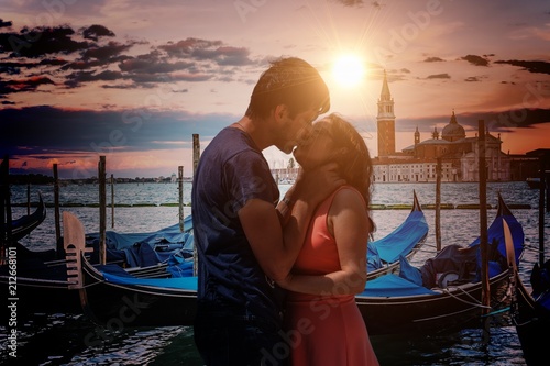 Young couple in love is kissing in Venice in Italy.