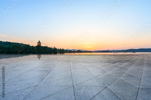 Empty square floor and hill silhouette at dusk
