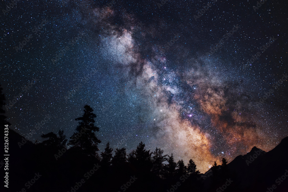 Fototapeta premium Astrofotografia galaktyki Drogi Mlecznej. Sylwetka gór. Gwiazdy, mgławica i gwiezdny pył w krajobrazie nocnego nieba